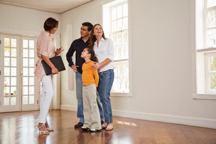 Realtor with family in empty room